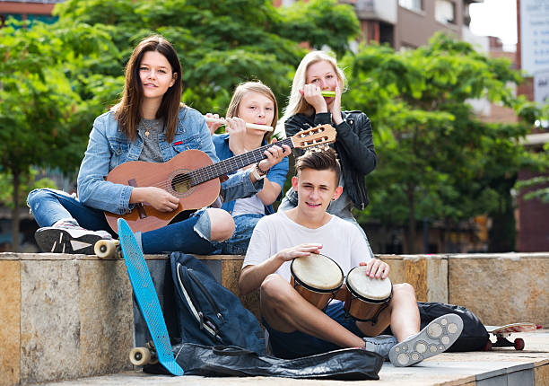 Teenagers friends playing musical instruments