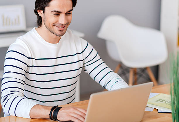 istock Cheerful man sitting at the table 547414108