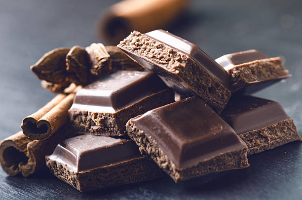 two chocolate buildings on a dark background. energy and sugar. - culture and entertainment imagens e fotografias de stock