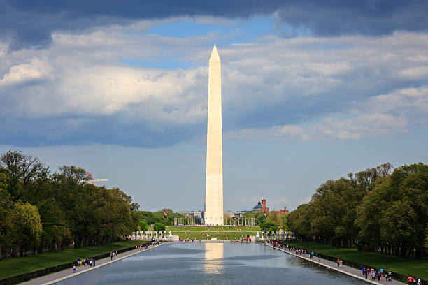 istock Sun illuminating the Washington monument through a hole in the 547414256