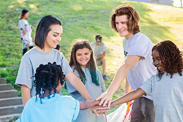istock Volunteer group put their hands in during pep talk 547414290