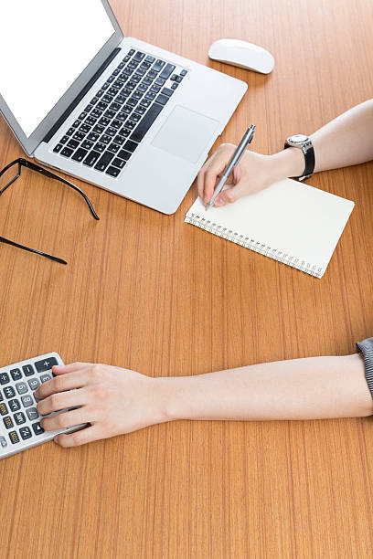 istock businessman working with calculator and computer laptop on office desk 547414514