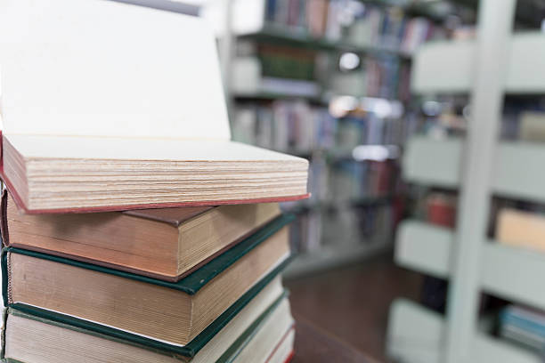 istock old book on wooden table with blur library background 547414858