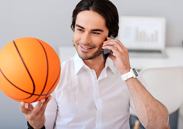 istock Joyful man holding basket ball 547415860