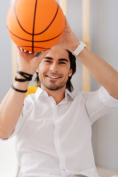 istock Positive man holding basket ball 547415996