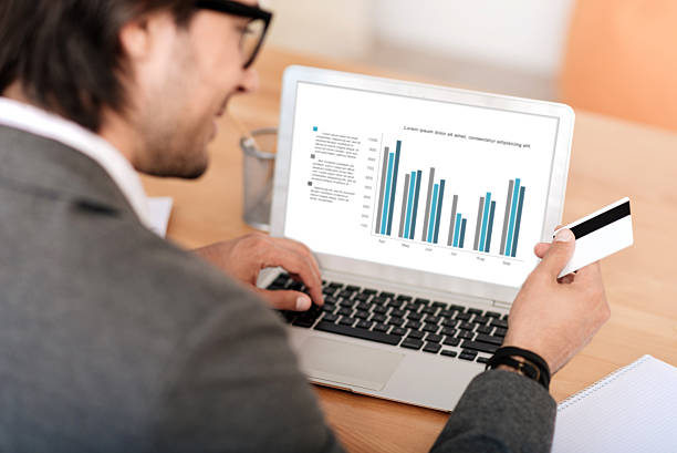 istock Smiling businessman sitting at the table 547416782