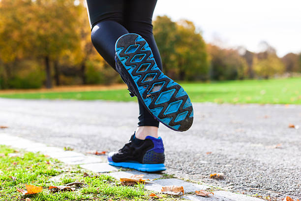 istock Woman sport running through autumn or fall park 547417116
