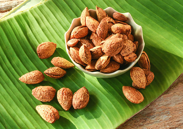 istock Almonds for snacks on green banana leaf background. 547417248