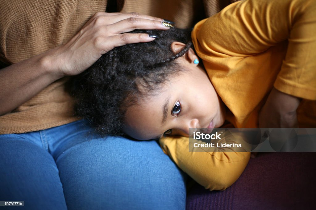 Family problems. Little girl is illness. Napping on mother lap. Child Stock Photo