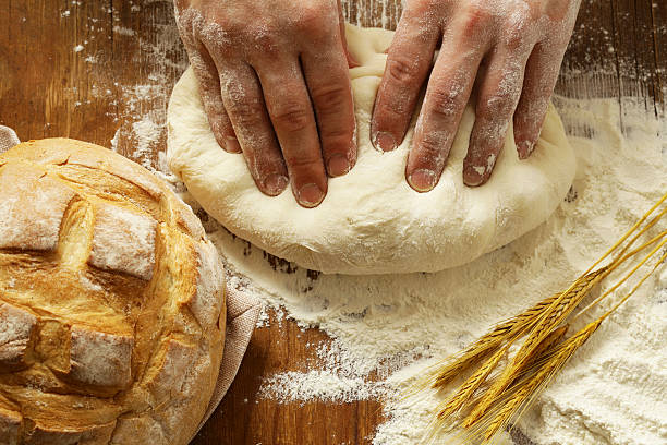 istock Chef hands with dough and homemade bread and flour 547419684