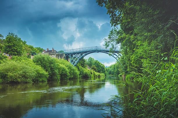 Ironbridge A stock photo of Iron bridge in Shropshire, England. It lies in the civil parish of The Gorge, in the borough of Telford and Wrekin. The famous Iron Bridge is a 100 ft cast iron bridge that was built across the river in 1779. Photographed with the Canon EOS 5DSR. ironbridge shropshire stock pictures, royalty-free photos & images