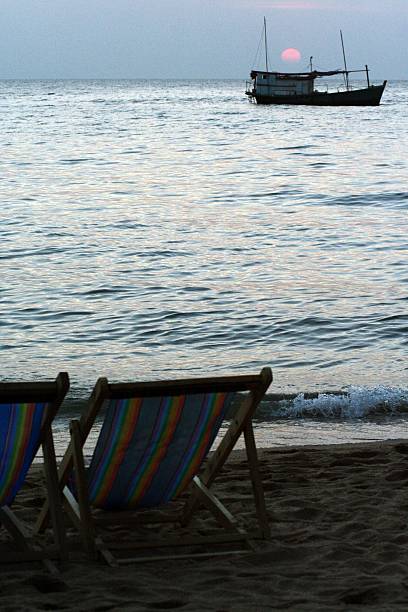 One sun lounger on the beach near the sea. Rainy sea.