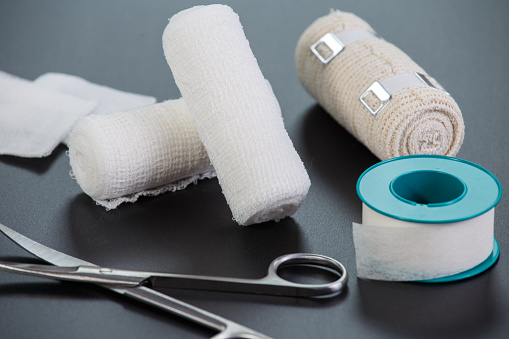 Medical bandages with scissors and sticking plaster