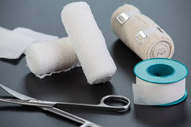 Medical bandages with scissors and sticking plaster