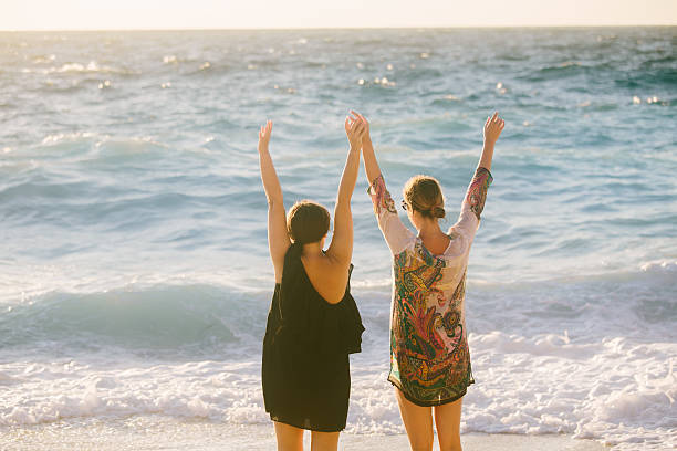 istock Two female friends having fun at the beach 547422418