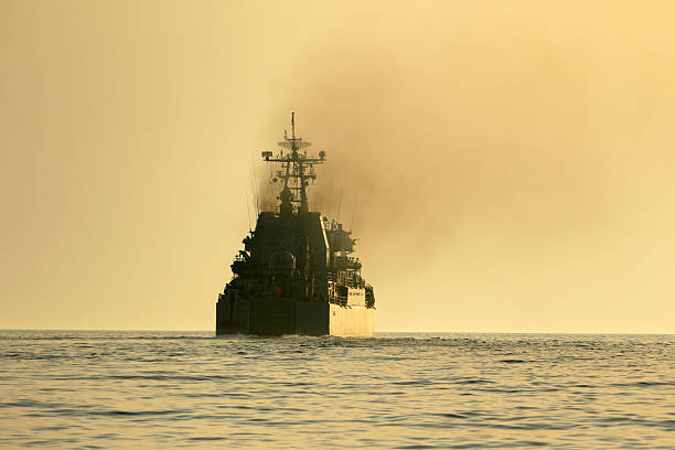istock silhouette of a warship at sunset 547422908