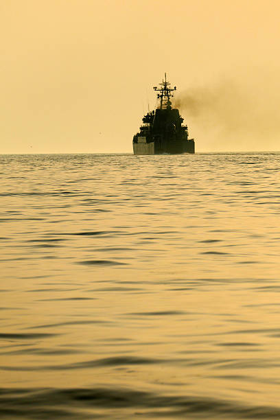 istock silhouette of a warship at sunset 547422988