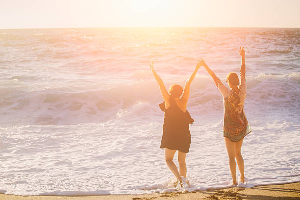 istock Two female friends having fun at the beach 547423080