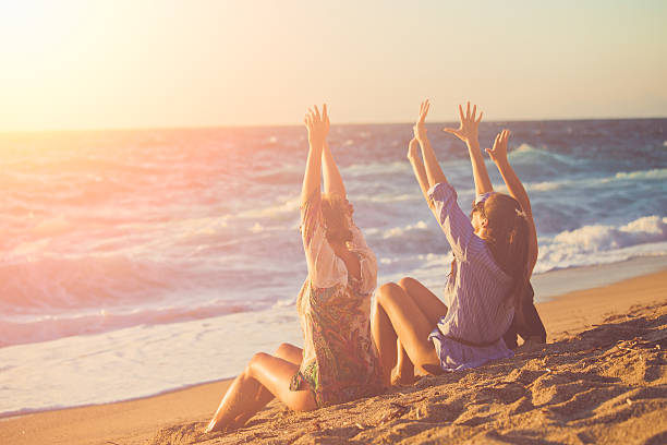 three female friends having fun at the beach - group of objects travel friendship women imagens e fotografias de stock