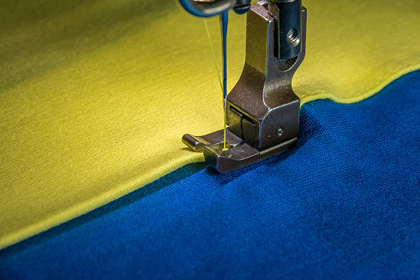 istock Professional sewing machine with yellow and blue fabric 547426194