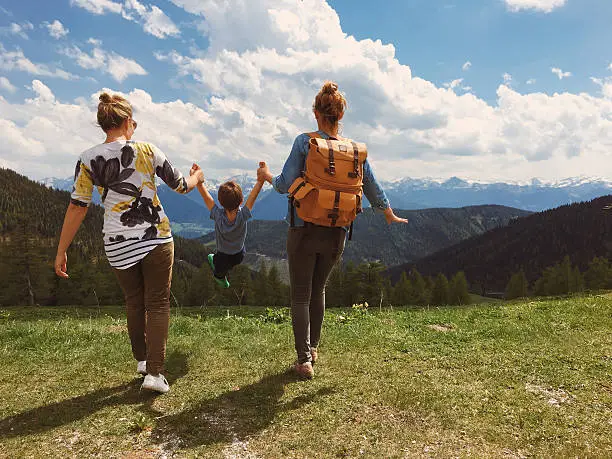 Two young women and little boy enjoying the nature of the Austrian Alps