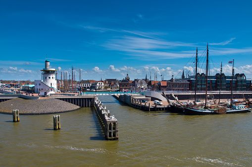 Leer, Germany - October 27, 2022: The skyline of the old town of Leer, city in East Frisia, Lower Saxony. With ships on the Leda river, town hall and bridge on a splendid day in autumn.