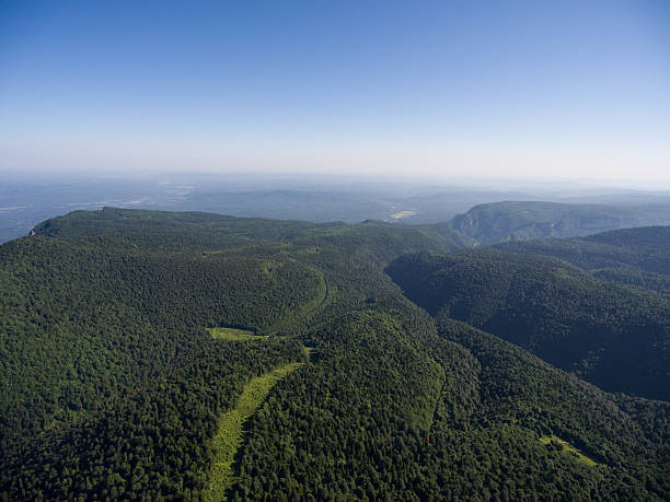 istock Mountain ridge covered forest. Road in the forest. Mountain landscape. 547428664