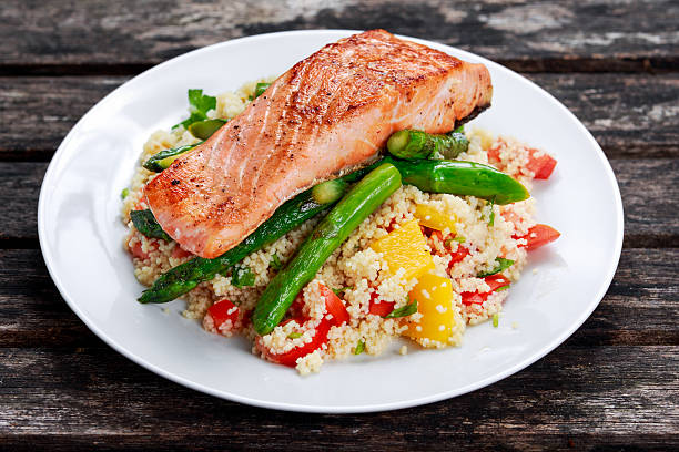 istock Pan fried salmon with tender asparagus and courgette served on 547428762