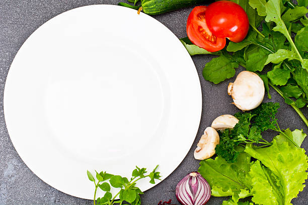Fresh Spring Vegetables, Greens and Empty  Plate with Place for Your Text Studio Photo