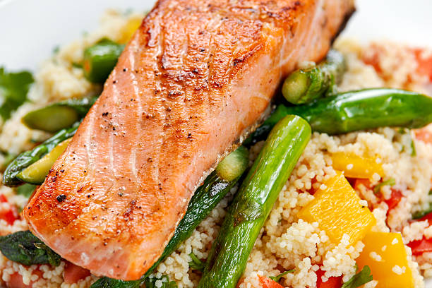 istock Pan fried salmon with tender asparagus and courgette served on 547428872