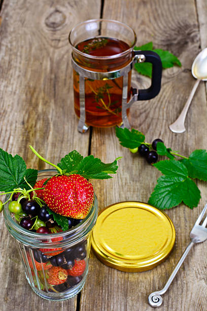 istock Strawberry, Black Currant and Tea on Wooden Rustic Background 547431934