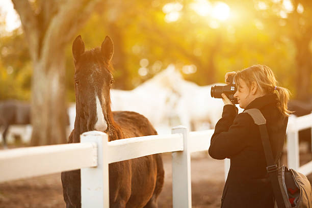 istock Young woman using a camera to take photo outdoor. 547433570