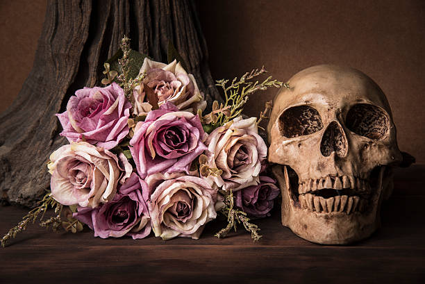 istock Bouquet purple roses with human skull 547434152