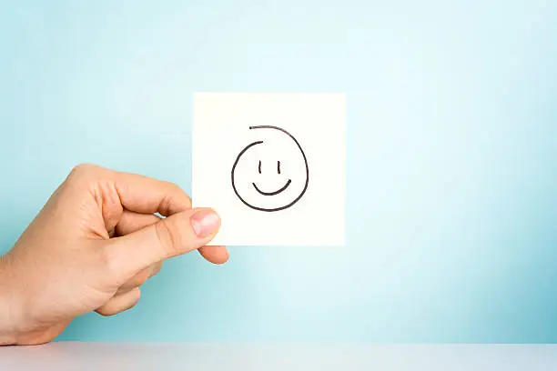 Photo of Happy employee. Happy emoticon or icon on blue background.