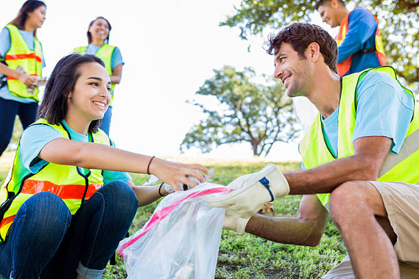 istock Diverse group of neighbors clean up their community 547436924