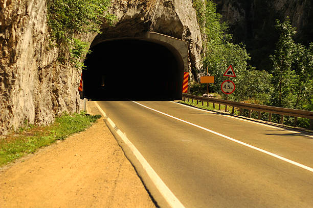 Asphalt road with tunnel entrance.