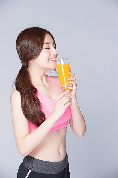 istock young girl drink orange juice 547438614