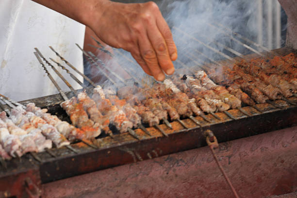 cooking traditional food kebab in xinjiang,china - urumqi stockfoto's en -beelden