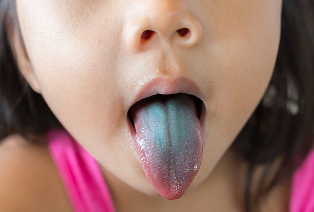 istock young kid with blue tongue 547440394