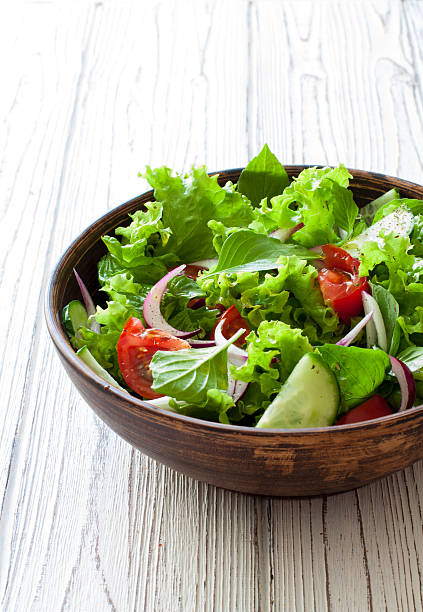 istock Vegetable salad with fresh lettuce, tomatoes and cucumber 547441088