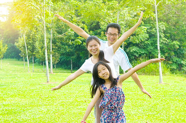 Four diverse children stand hand in hand in a sunny meadow, smiling and exploring together. This image captures friendship, outdoor play, and a cheerful moment perfect for family, education, or community themes.