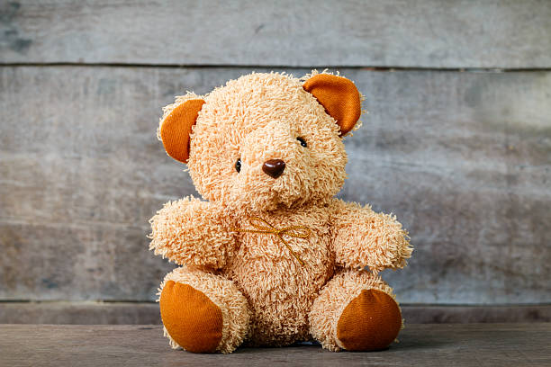 istock Cute teddy bears sitting on old wood background 547443224