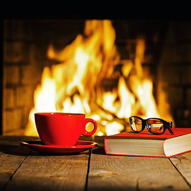 istock Red cup of coffee or tea, glasses and old book 547446490