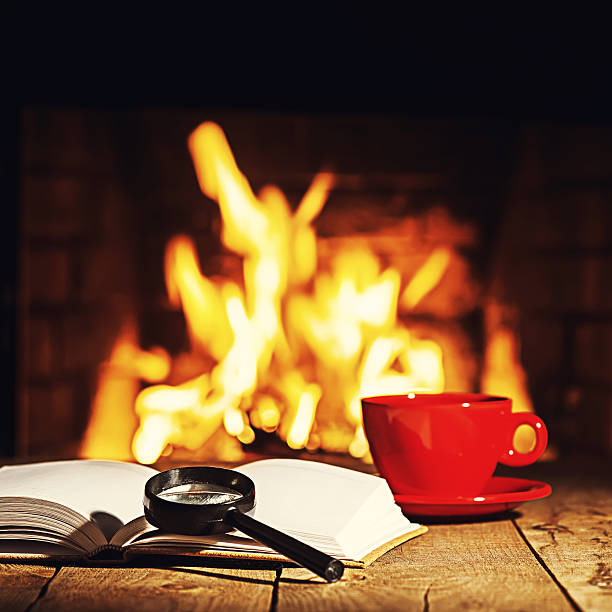 istock Red cup of coffee or tea, magnifier glass and book 547446546