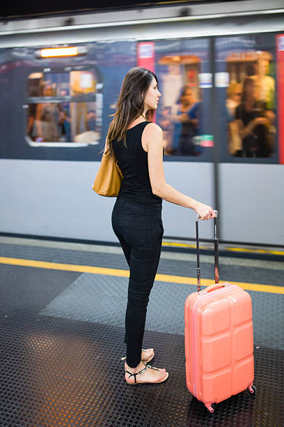 istock Woman is waiting train with suitcase 547446894