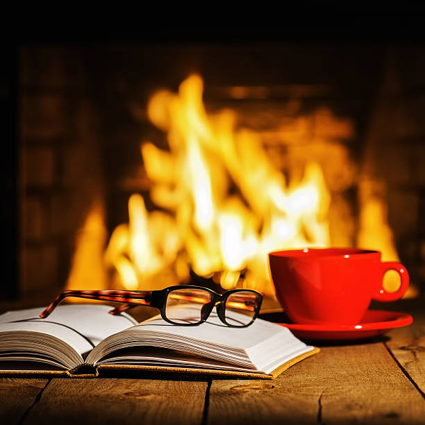 istock Red cup of coffee or tea, glasses and old book 547447140