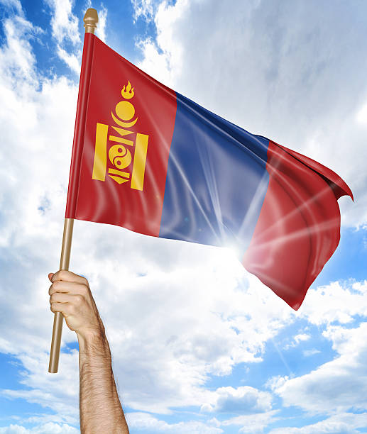 person's hand holding the mongolian national flag and waving it - independent mongolia fotos imagens e fotografias de stock