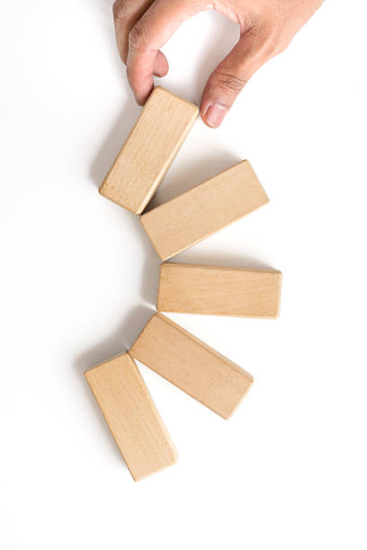istock Hand aranging wood block stacking as step stair. 547448720