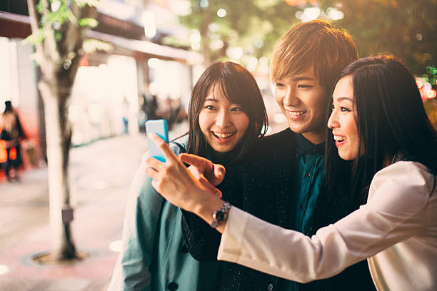 istock Happy japanese friends surfing the net 547450200