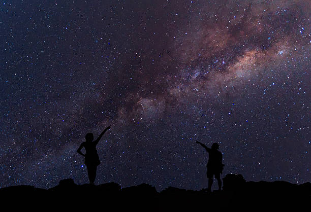 istock Person is standing next to the Milky Way galaxy 547451416